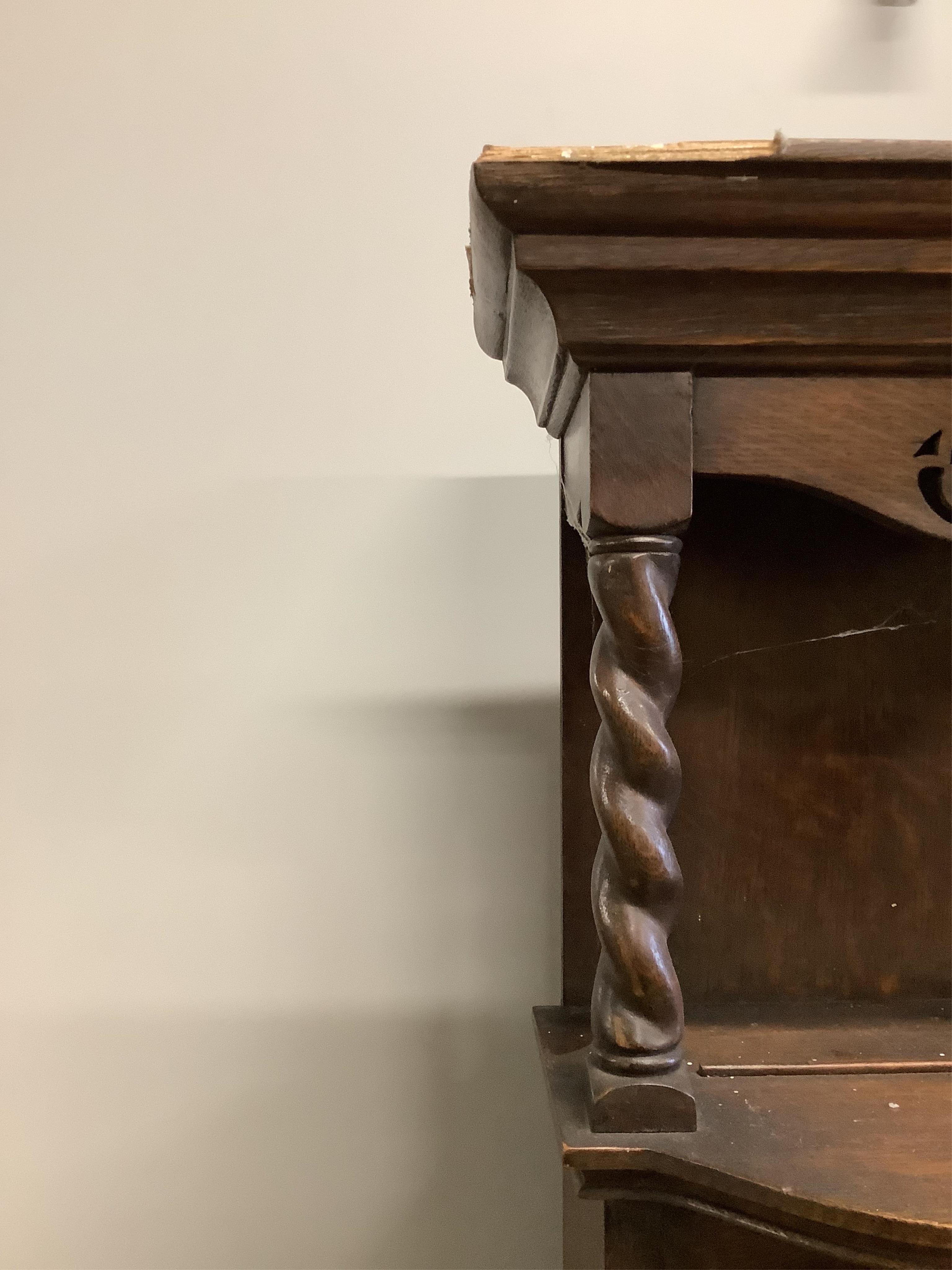 An early 20th century Liberty style oak dresser, width 157cm, height 208cm. Condition - damage to the top left of the cornice otherwise looks to be in good order